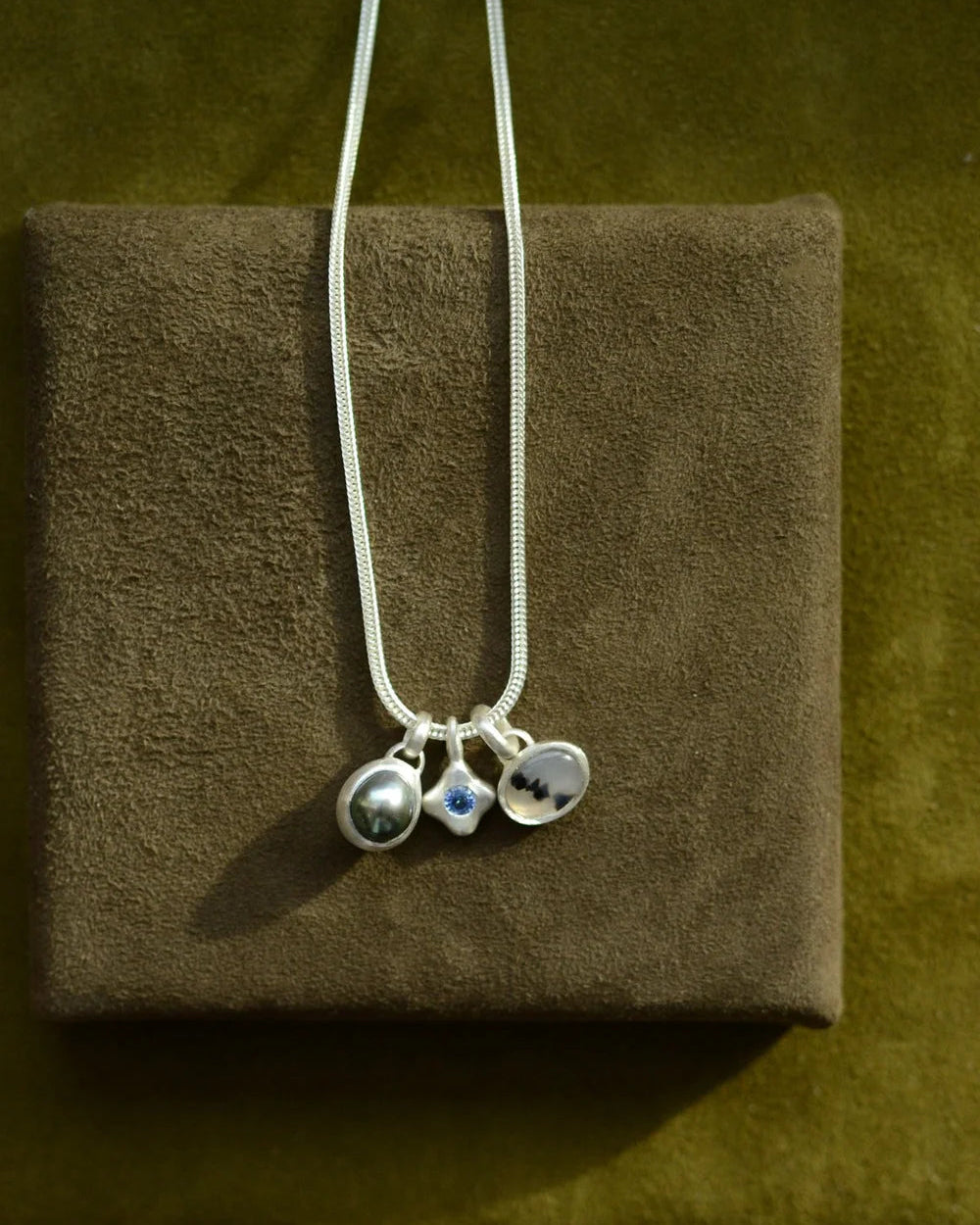 "Dunton Ellerkamp" Blue Sapphire and Silver Owen Solitaire Pendant